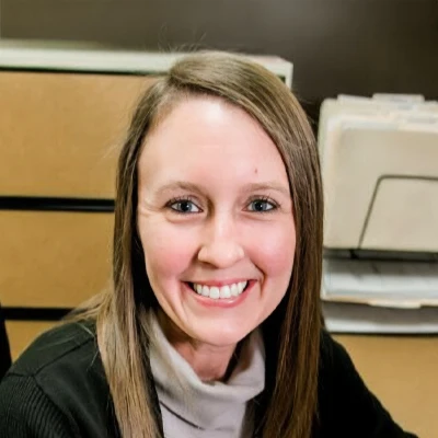 a head shot of the LaGrange Dentistry office manager, Ashley B. sitting at her desk