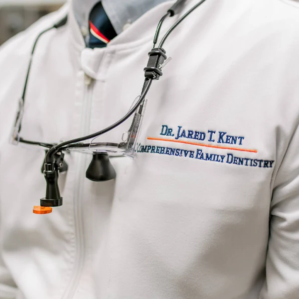 Dentist LaGrange GA Dr. Jared T. Kent Doctors Coat A close up shot of Dr. Kent in his doctors coat with detailed embroidery featured on the top left side
