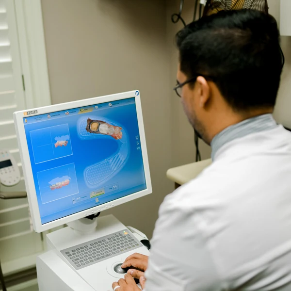 photo of Dr. Jared Kent from behind adding information to a computer