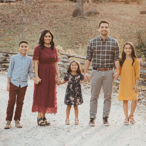 Dentist LaGrange GA Jared Kent and His Family Dr. Jared Kent is seen outside holding hands with his 3 children and wife