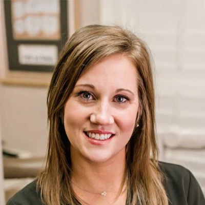 Dental Assistant, Kendra J. is pictured smiling at prospective patients for a head shot