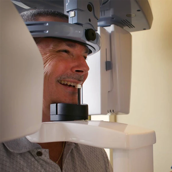 Dentist LaGrange GA Smiling Patient Receiving X-Rays a male patient is grinning while receiving dental x-rays at LaGrange Dentistry